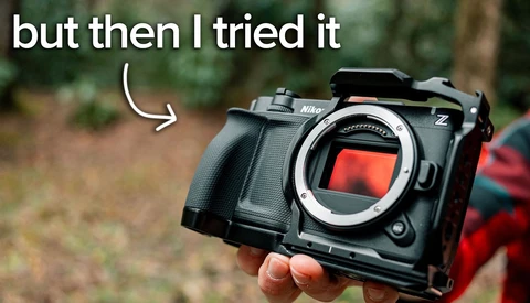 Nikon Z mirrorless camera body held in hand outdoors with meme text overlay