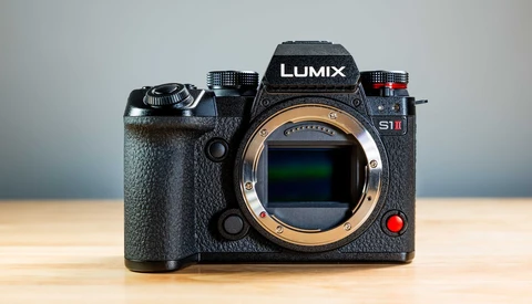 Panasonic Lumix S1H mirrorless camera with open sensor bay on wooden surface