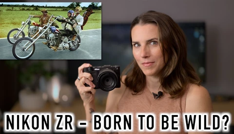 Woman holding Nikon ZR camera with inset image of motorcycle stunts