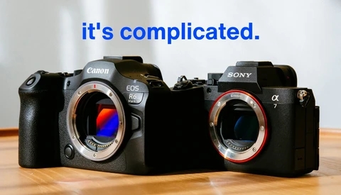 Canon EOS R6 and Sony α7 mirrorless cameras positioned side-by-side with text overlay reading 'it's complicated.'