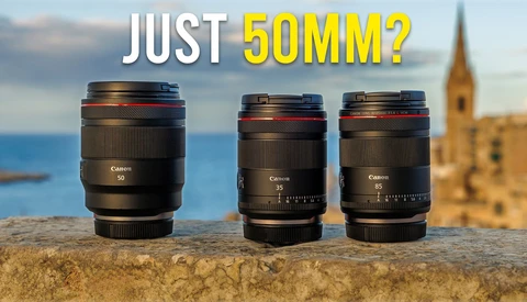 Three Canon RF-mount lenses displayed on a stone wall with Mediterranean coastline and church tower in background