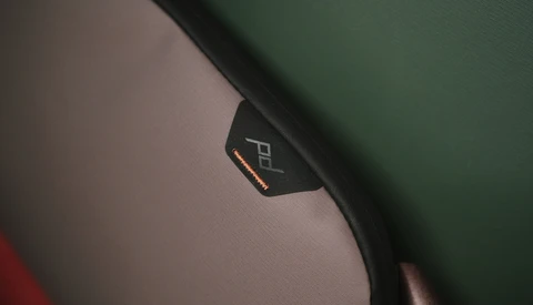Close-up of a camera strap with brand logo and orange accent stitching