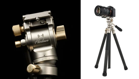 Hanlace fluid head tripod mount with brass handles shown in profile against black background, paired with camera on tripod rig