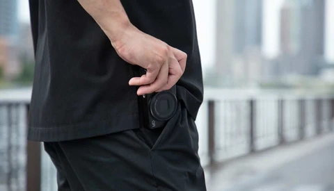 Man in black clothing with empty wallet pocket in urban setting