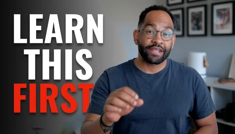 Man in glasses pointing at camera with text overlay 'LEARN THIS FIRST'
