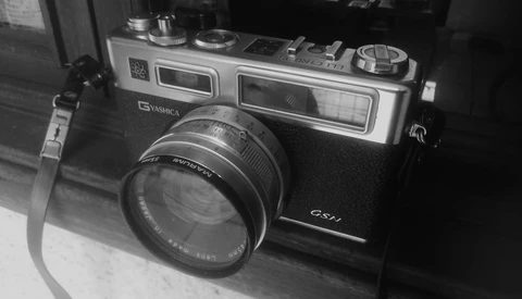 Vintage rangefinder camera with dual viewfinders and standard lens in black and white