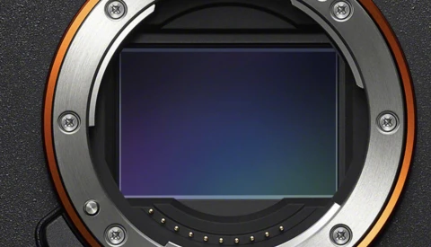 Camera sensor and mirror assembly viewed through open mount showing blue-tinted sensor surface