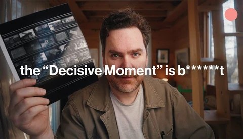 Man holding a contact sheet with text overlay about decisive moments in photography