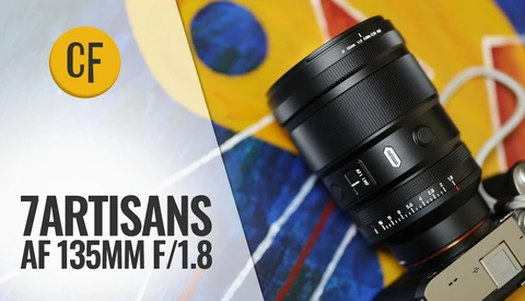 7Artisans AF 135mm f/1.8 lens mounted on camera body with colorful abstract background