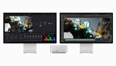 Three monitors displaying color grading software with VFX imagery of crystalline rock formations with glowing green and yellow light effects