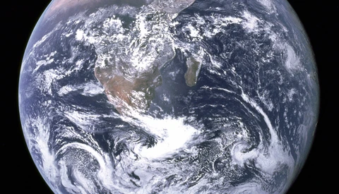 Full-disc view of Earth from space showing the African continent, swirling white clouds, and deep blue oceans against black space.