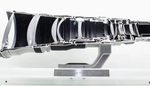Cutaway diagram of a telephoto lens showing internal optical elements and mechanical components