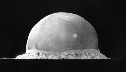 Monochrome photograph of a spherical dome-shaped object with granular base material against black background