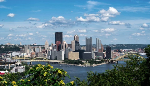 Pittsburgh skyline with Golden Triangle downtown district reflected in river, viewed from elevated vantage point