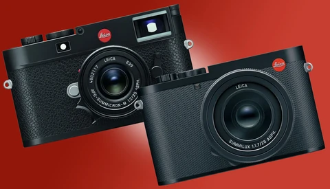 Two Leica rangefinder cameras displayed against a red background