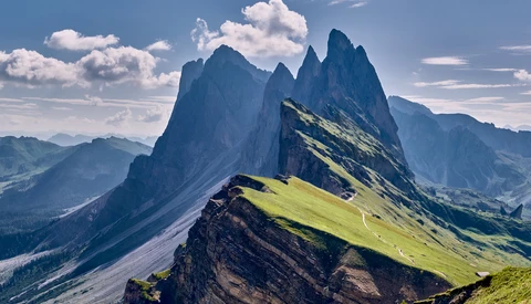 Säntis mountain peak with dramatic vertical rock formations and green alpine meadows in Swiss Alps