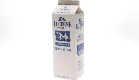 Lucerne skim milk carton with blue cow logo on white background