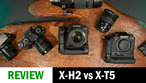 Fujifilm X-H2 and X-T5 cameras with lenses arranged on wooden surface for comparison review
