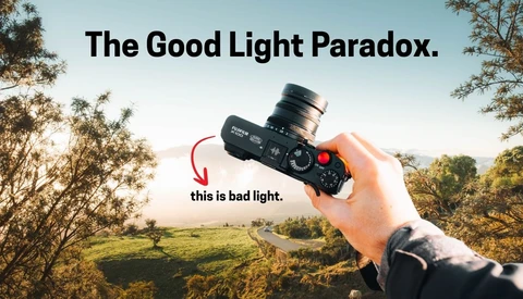 Graphic illustration titled 'The Good Light Paradox' showing a hand holding a cinema camera against a golden-hour landscape, with an arrow labeling the backlit scene as 'bad light'