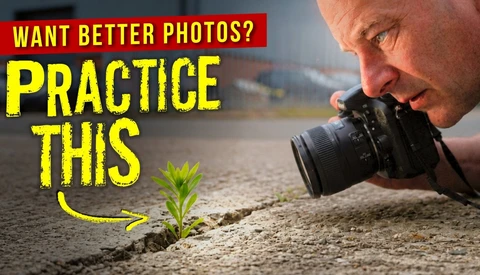 Photographer shooting macro of small plant sprout at ground level with DSLR camera