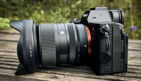Sony mirrorless camera with wide-angle lens on wooden surface outdoors