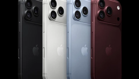 Four smartphone models displayed in black, white, light blue, and deep red finishes against a black background