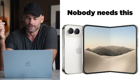 Man in black cap and shirt skeptically reviewing a foldable smartphone device