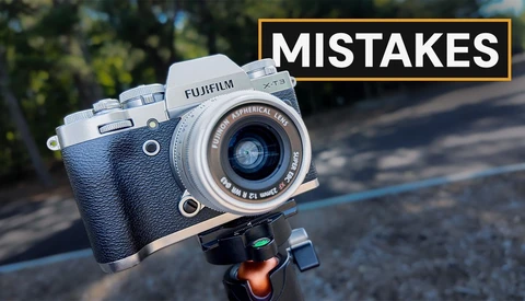 Fujifilm X-T1 camera on tripod head with yellow text overlay reading "MISTAKES"