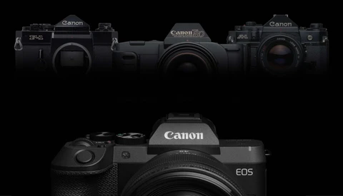 Canon EOS mirrorless camera displayed front and center with three vintage Canon film cameras arranged above
