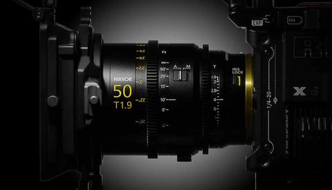 Nikon 50mm f/1.9 lens with technical specifications and optical diagram overlay