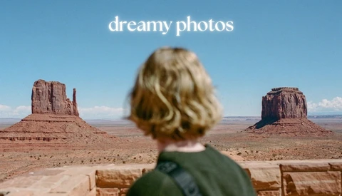 Person with blonde wavy hair viewing Monument Valley's iconic buttes from behind