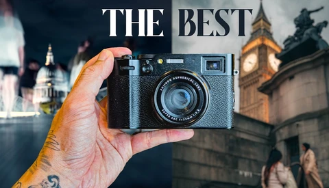 Hand holding a black Fujinon compact camera before a split London backdrop of St Paul's Cathedral and Big Ben.