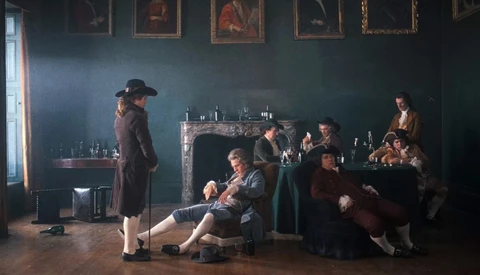 Gentlemen in 18th-century dress lounging and drinking in a dim room with gilt-framed portraits and a marble fireplace.