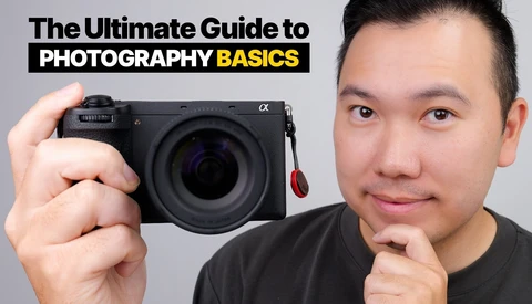 Smiling man holding a Sony Alpha mirrorless camera, with the title 'The Ultimate Guide to Photography Basics' overhead.