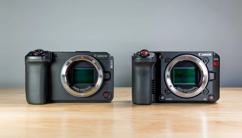 Two Canon cinema cameras displayed side by side on wooden surface