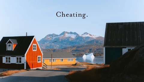 Colorful houses in an Arctic settlement with snow-capped mountain and text reading 'Cheating' overlaid