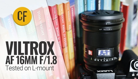 Viltrox AF 16mm f/1.8 lens positioned in front of colorful book spines