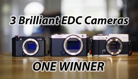 Three mirrorless camera bodies without lenses on a wooden table, with overlaid text reading "3 Brilliant EDC Cameras" and "ONE WINNER."