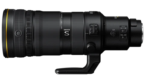 Nikon NIKKOR S telephoto zoom lens with gold accent ring and tripod collar, shown horizontally on a white background