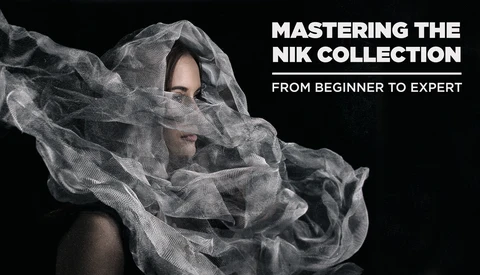 Person's face partially obscured by flowing translucent white fabric against a black background.
