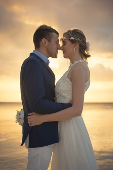 Sunset wedding with couple on beach by the sea
