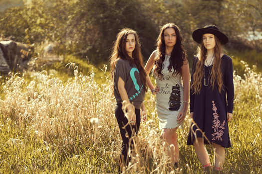 Hard sun used as back light Models for Spear and Arrow Apparel photographed in a field, back lit by hard sunlight