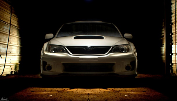 Subaru in a wash bay of an abandoned car wash facility being lit by four different strobe pops. Subaru Composite automotive photography photoshop adobe lightroom
