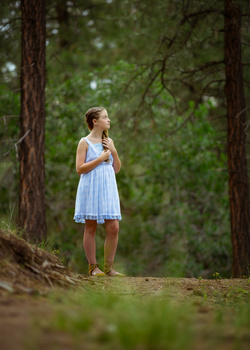 Portrait of a young girl taken from a crouched down position. portrait of a young girl taken from a crouched down position