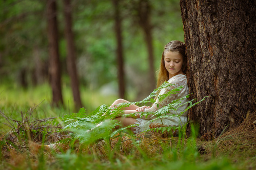 Portrait of a girl taken from a prone position close to the ground. portrait of a girl taken from a prone position close to the ground