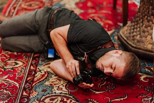 Writer Jason Vinson huddling up on the floor to get a shot