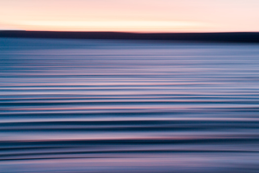 Abstract photograph of the sunset reflecting off of waves.
