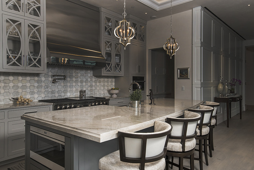a behind-the-scenes interior image where a kitchen island is lit and nothing else