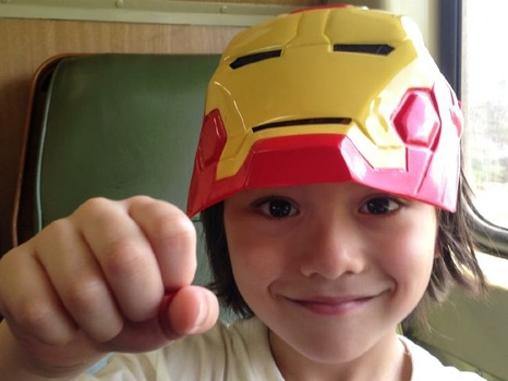 Julian Cadman wearing a Marvel Iron Man mask