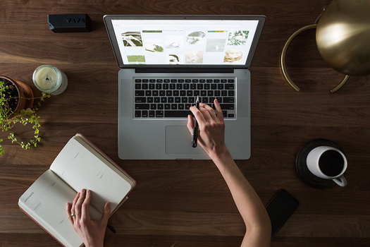 wedding photographer brainstorming ideas for marketing on computer